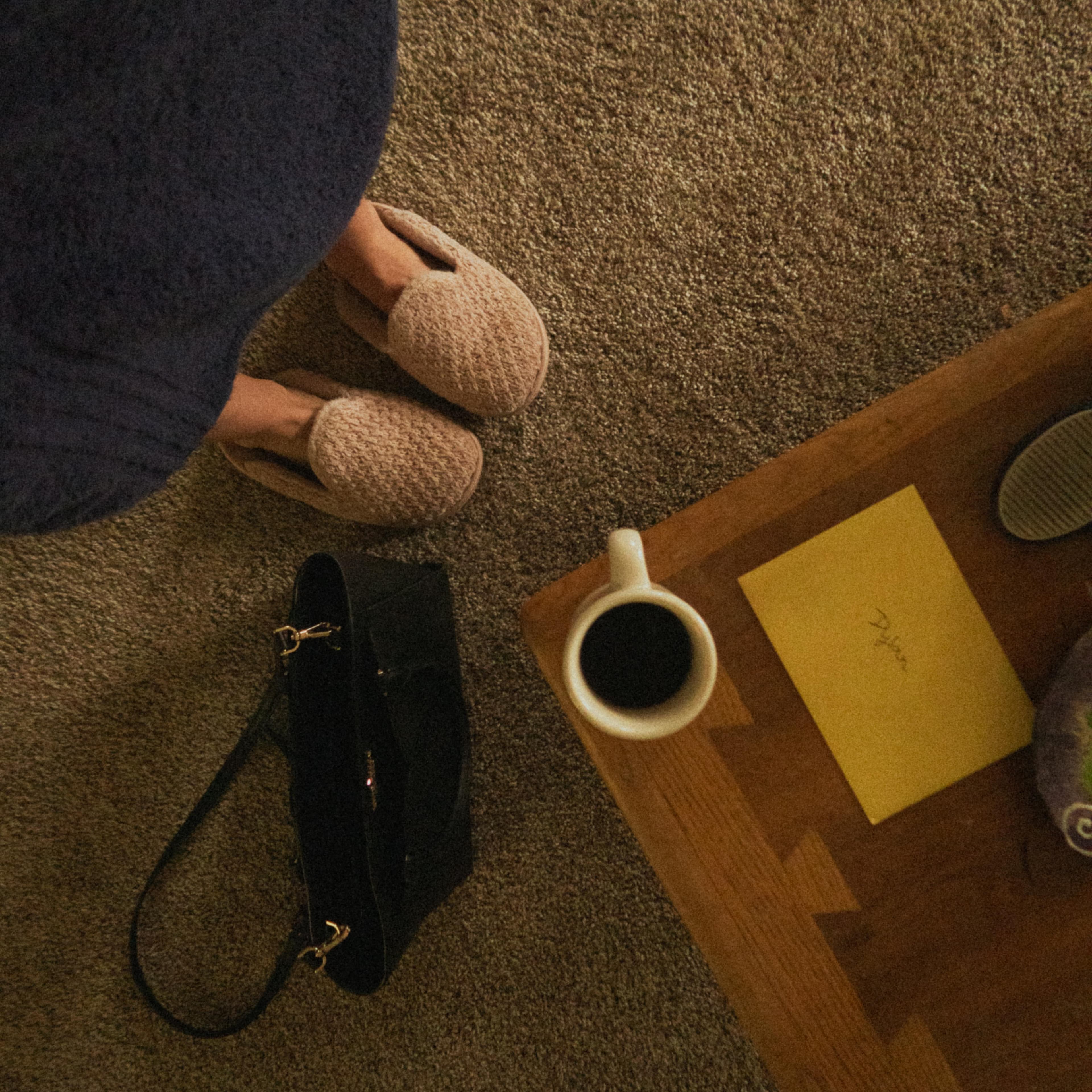 Relaxing morning scene with coffee, bathrobe, and slippers on cozy carpet.