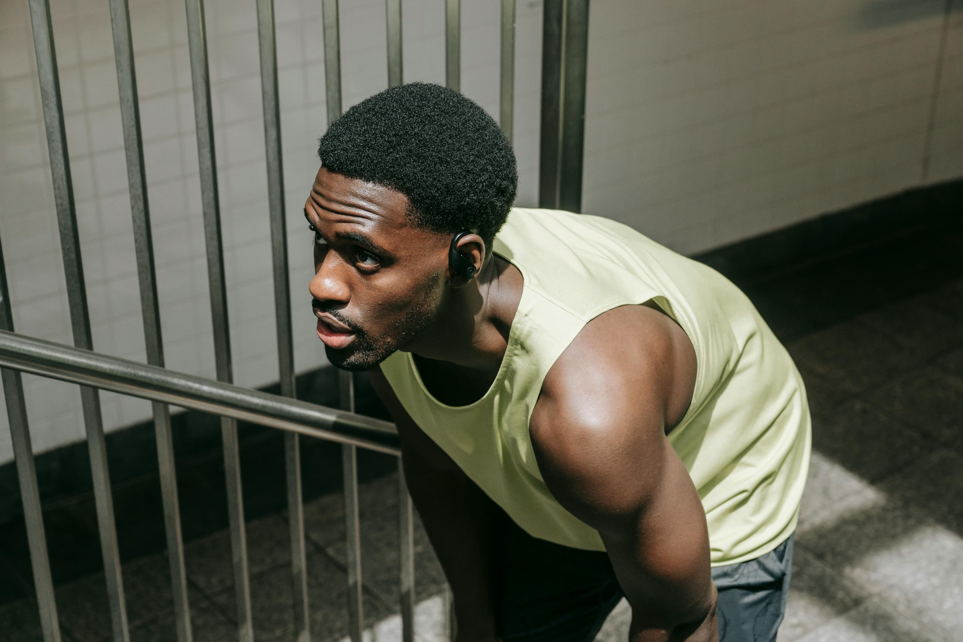 A muscular man in sportswear takes a break, showcasing focus and stamina.